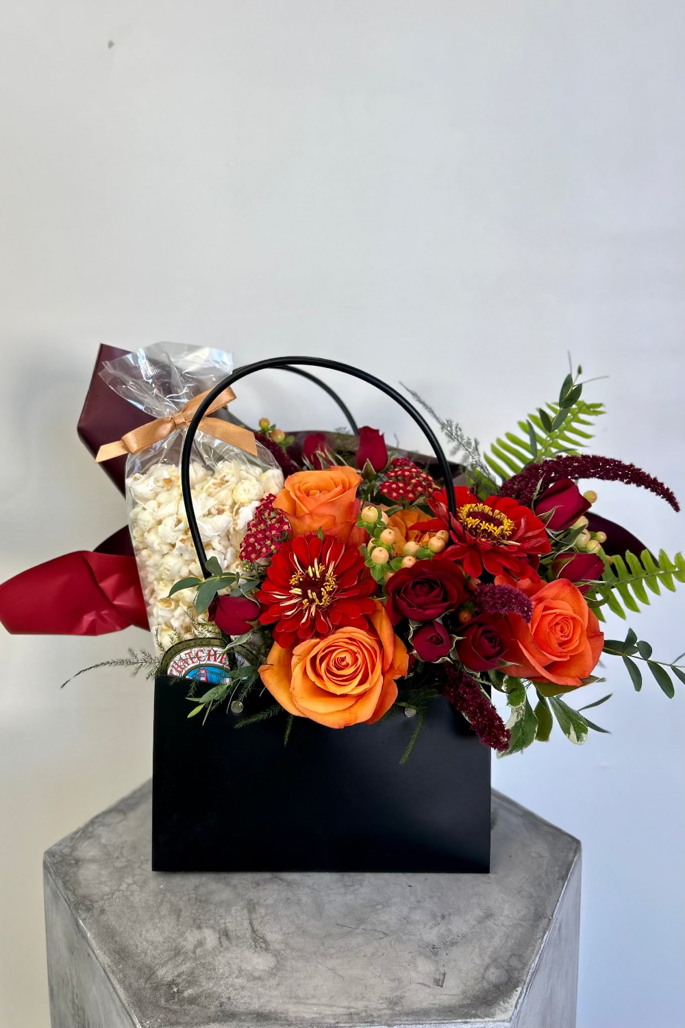 lush orange and red Floral arrangement with popcorn perfect gift for delivery in lone tree