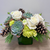 white roses succulents white ranunculus pine cones evergreens designed by a woman owned local castle pines florist the flower fix