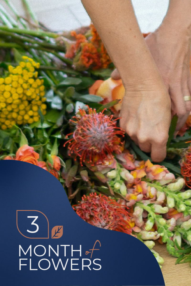 An assortment of colorful flowers and foliage arranged by a person's hands, with a promotional element indicating a '3 Month Flower Delivery' subscription.