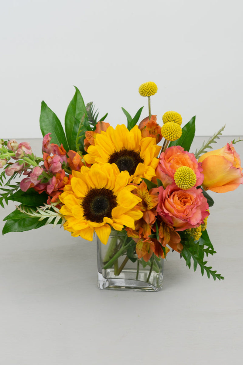 sunflowers, roses, lilies in orange, yellow and summer colors