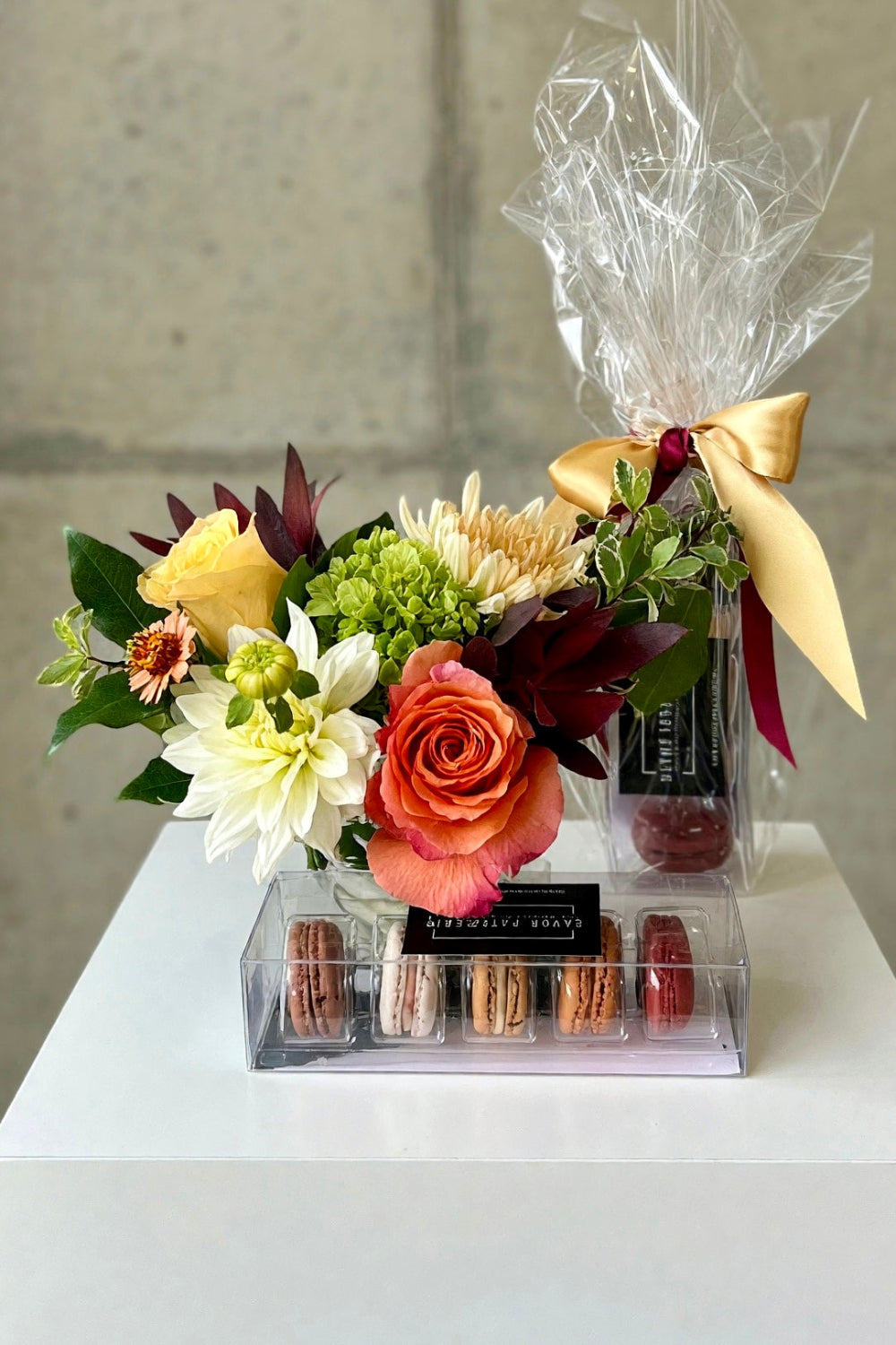 Autumn Bloom &amp; Bite Box featuring a desk-size fall bouquet in cream, coral, rust, and burgundy paired with a 5-flavor macaron sampler