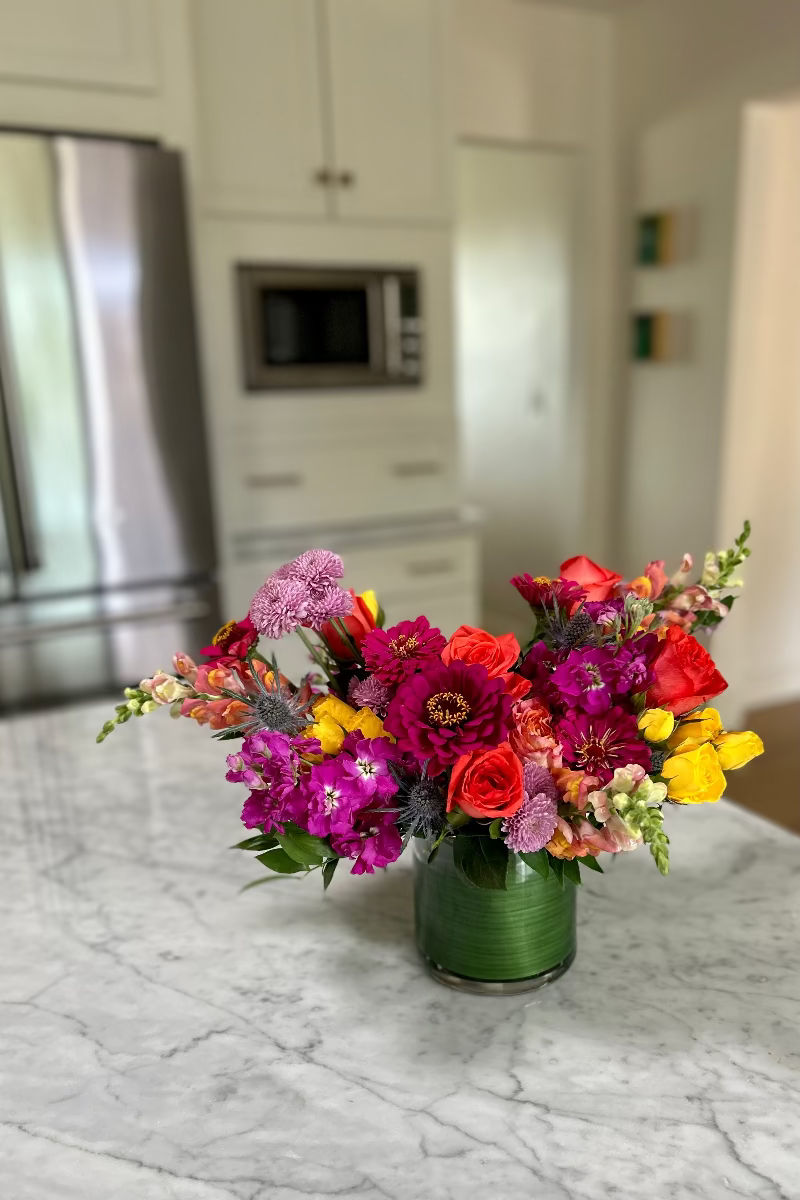 Bloomfetti signature bouquet displayed on a table with natural light highlighting bright, celebratory colors