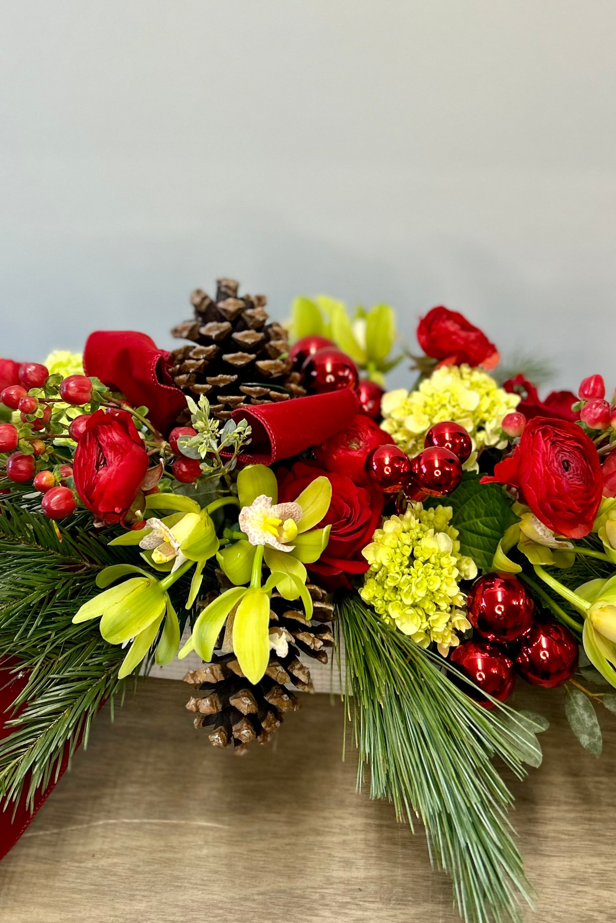 red velvet ribbon pine cones and evergreen christmas centerpiece