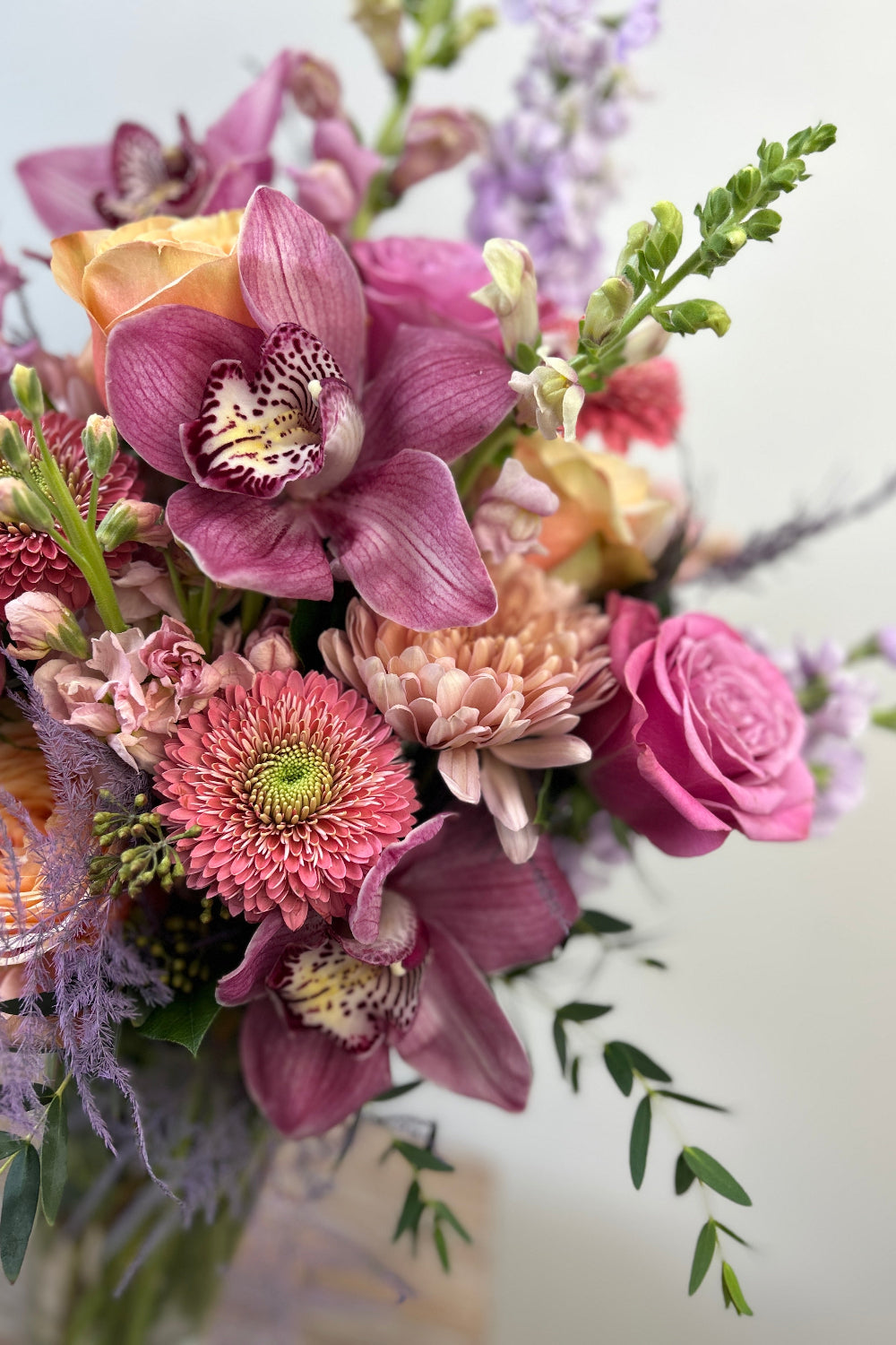Close-up of Pastel Hearts Bloom Vase showing lavender snapdragons, pink roses, peach cremones, gerbera daisies, and eucalyptus details