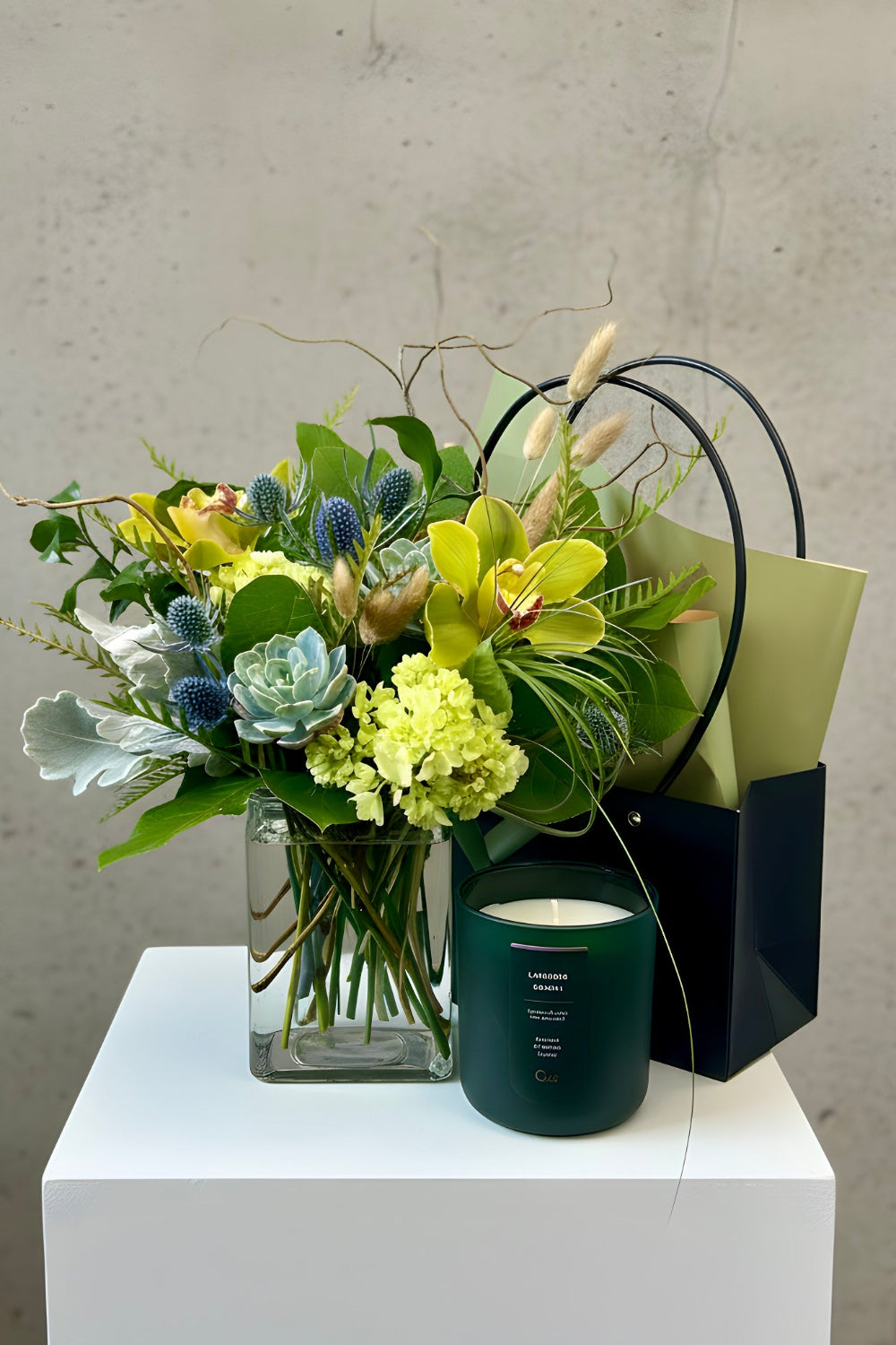 A woodsy Father’s Day bouquet with succulents, branches, thistle, and textured foliage paired with a balsam lavender candle, styled as the Colorado Forest &amp; Flame Gift Set.