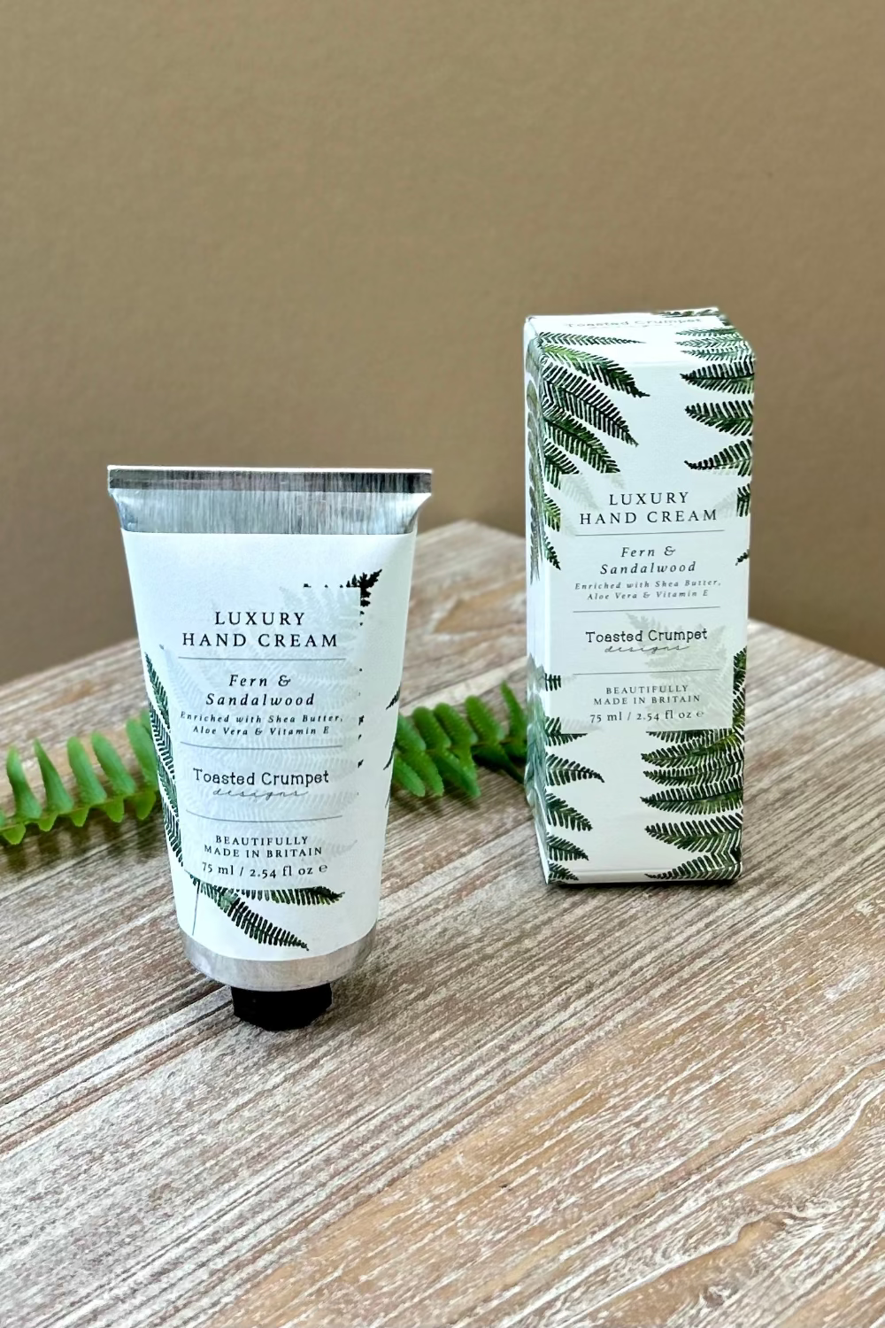 Luxury hand cream tube and packaging with fern design fern and sandlewood fragrance