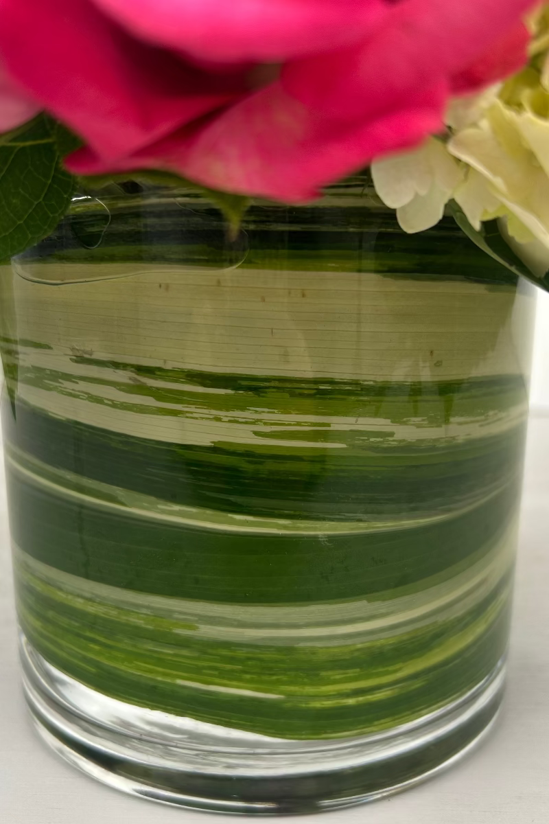 close up image of leaf wrapped glass vase