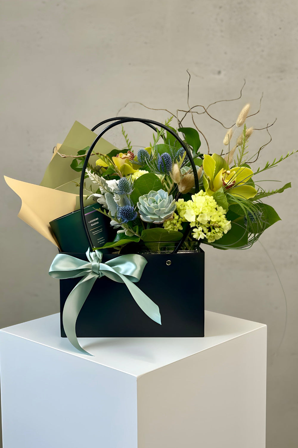 A premium Father’s Day gift bag holding the Colorado Forest &amp; Flame bouquet and balsam lavender candle.