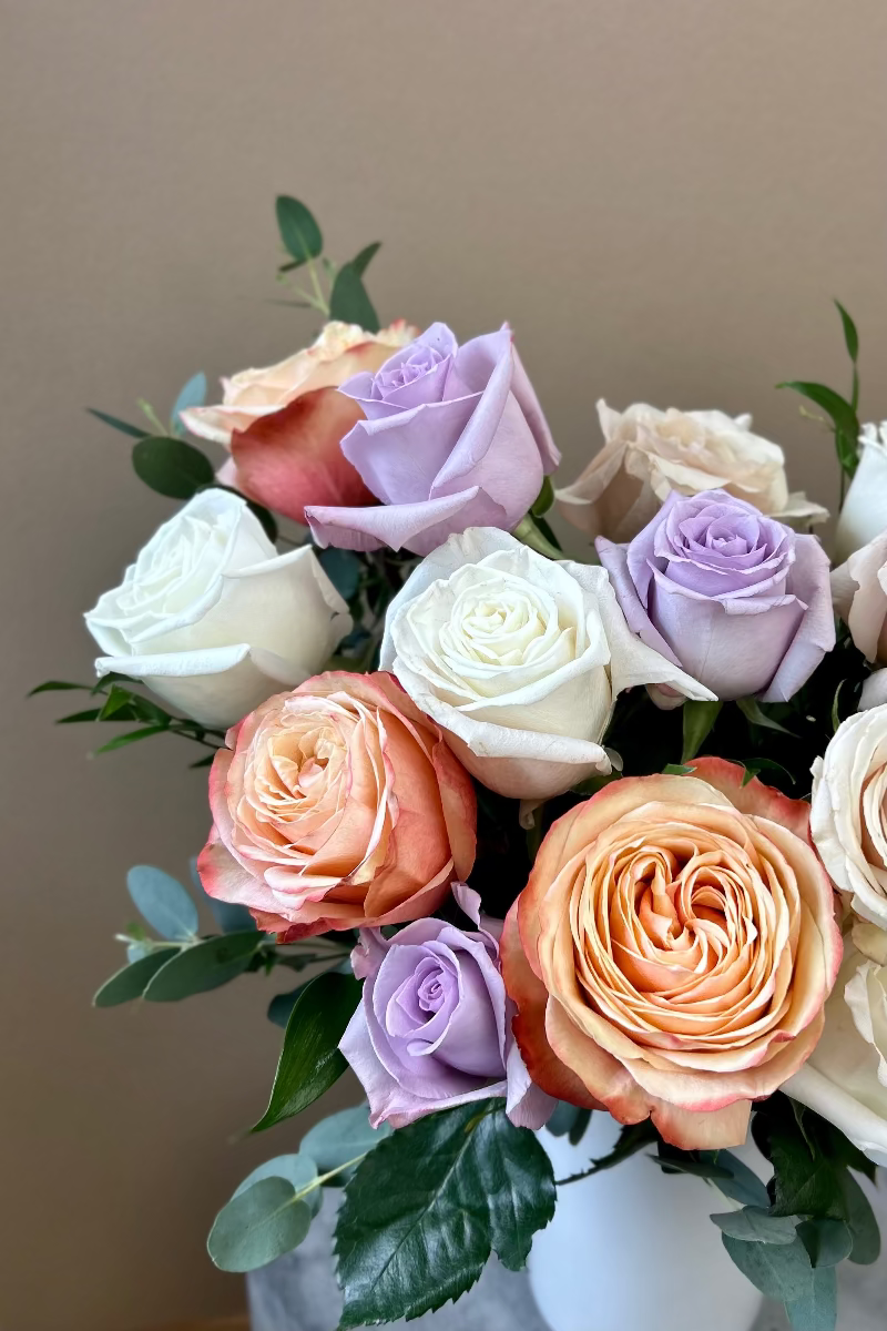 Close‑up of Rose Crème bouquet showing soft pastel and warm latte roses with delicate petal textures