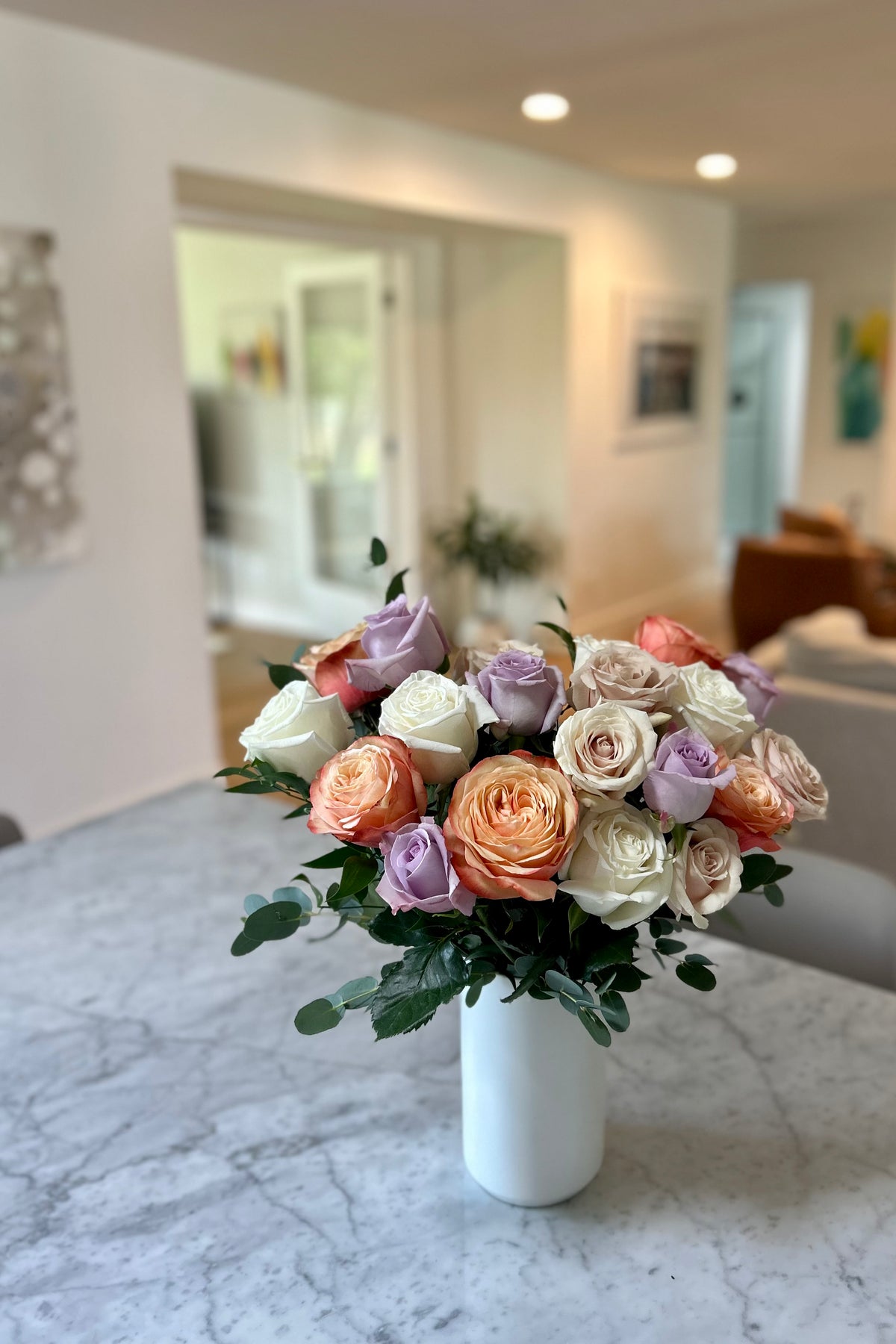 Rose Crème signature bouquet displayed on a table with natural light highlighting muted, romantic tones