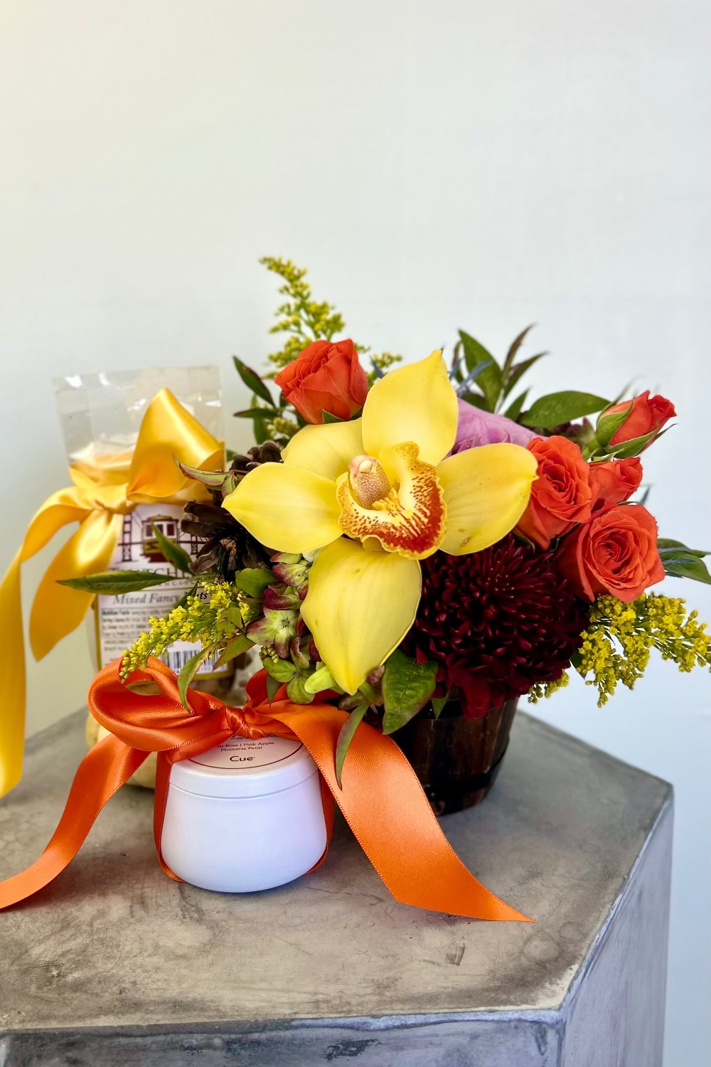 Amber Radiance Trio gift set with flower bouquet in wood barrel, fall candle, and Thatcher’s mixed nuts