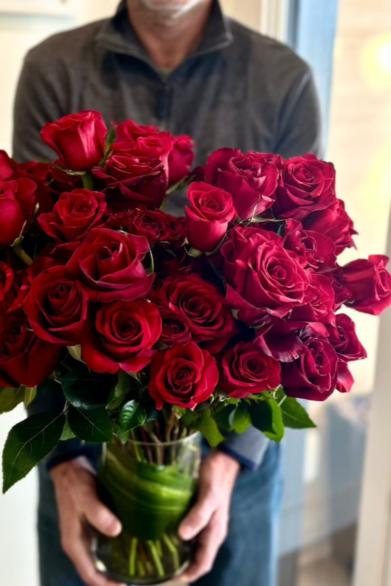 man-holding-huge-rose-bouquet