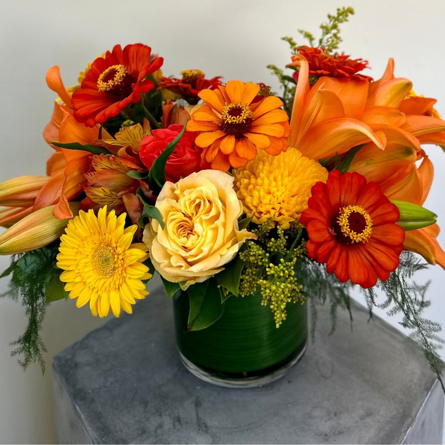 Bouquet of orange, yellow, and red flowers in a vase perfect fall centerpiece