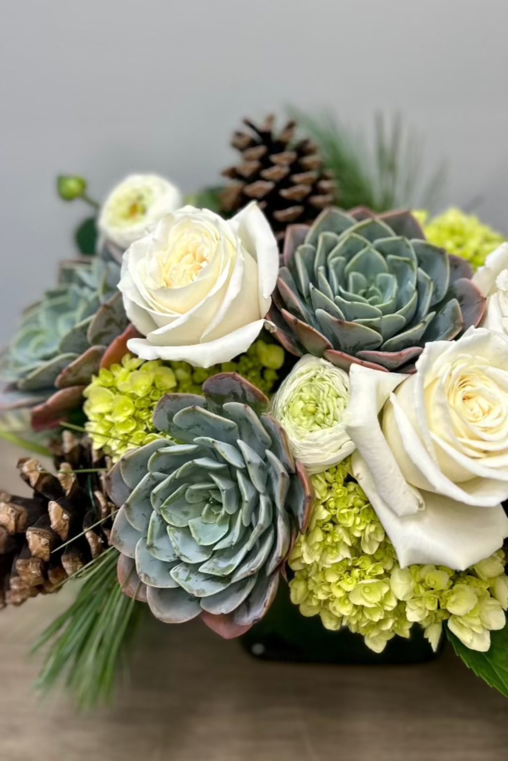 monochromatic roses ranunculus succulents pine cones hydrangea evergreens local lone tree and castle pines florist the flower fix