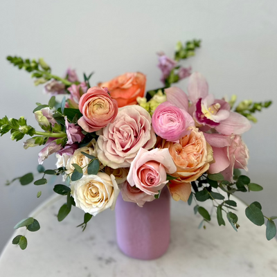 pink-roses-ranunculus-vase-orchids-snapdragons-eucalyptus