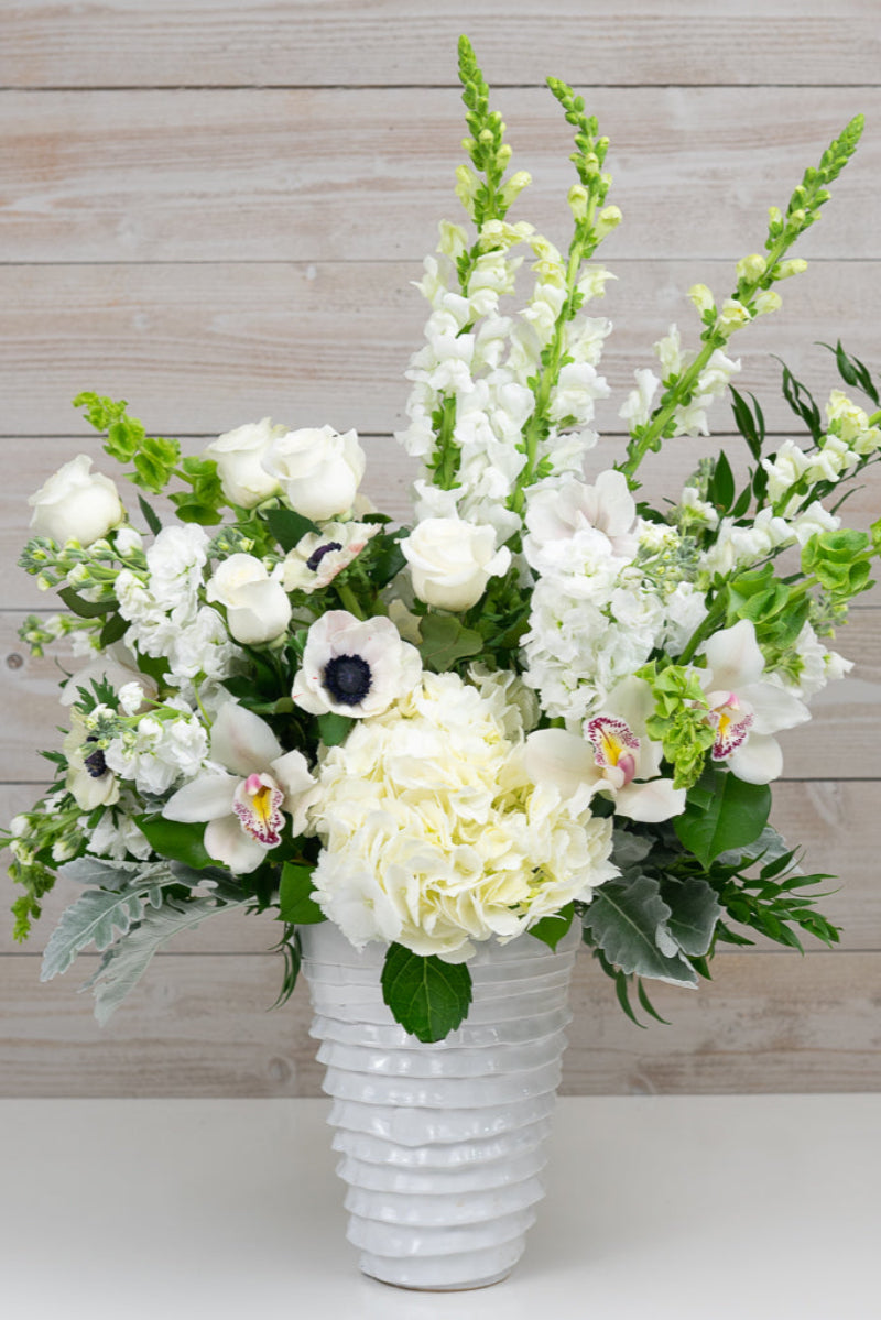 very large white flower bouquet with premium flowers in stylish container