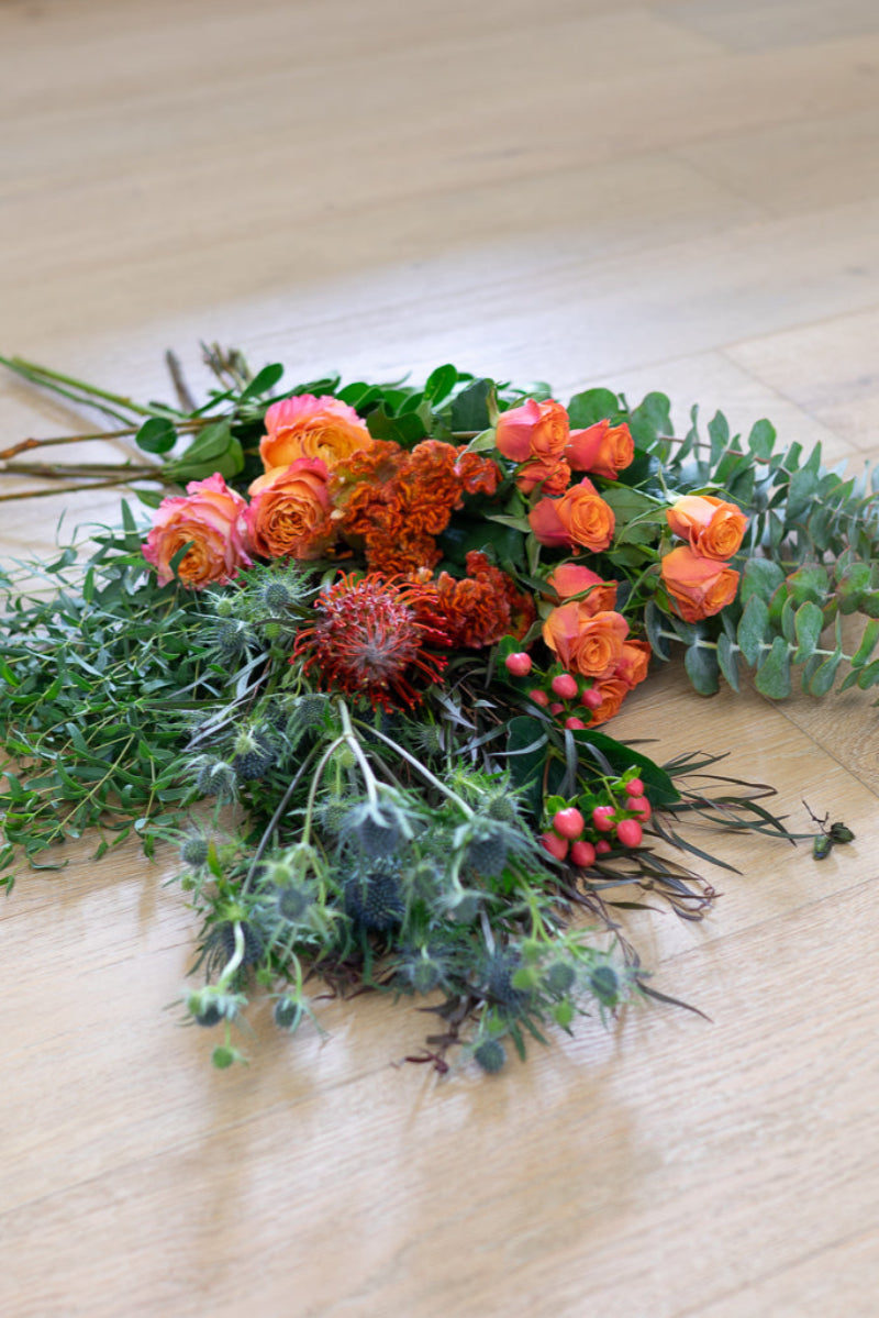 bouquet of fall colored roses displayed to show value