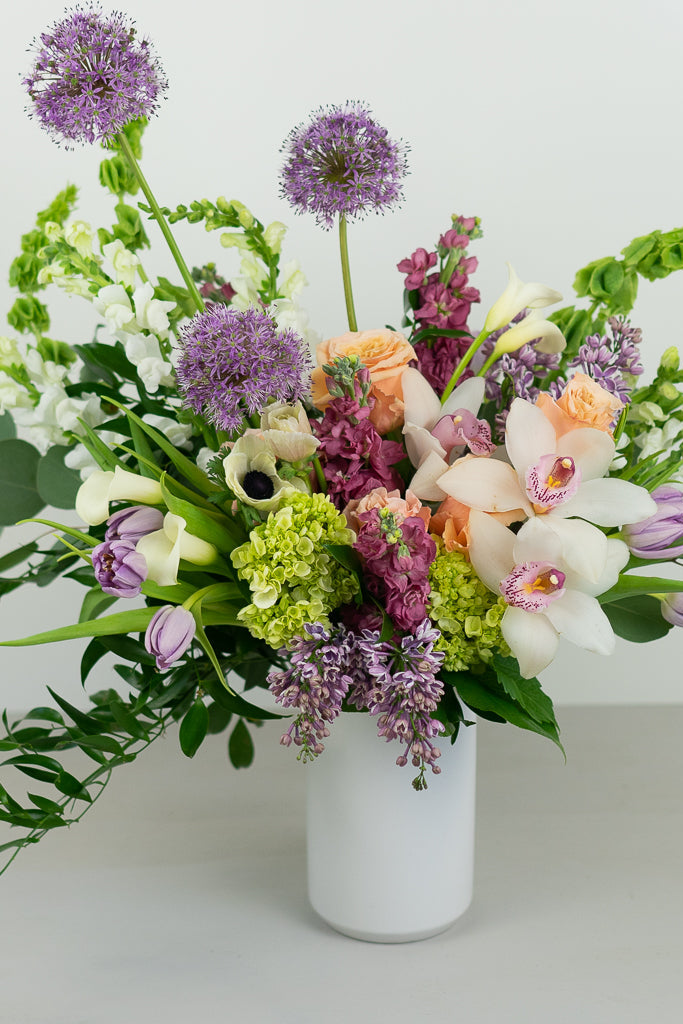 orchids, allium, tulips, calla lilies, lilac, spring flowers in a vase