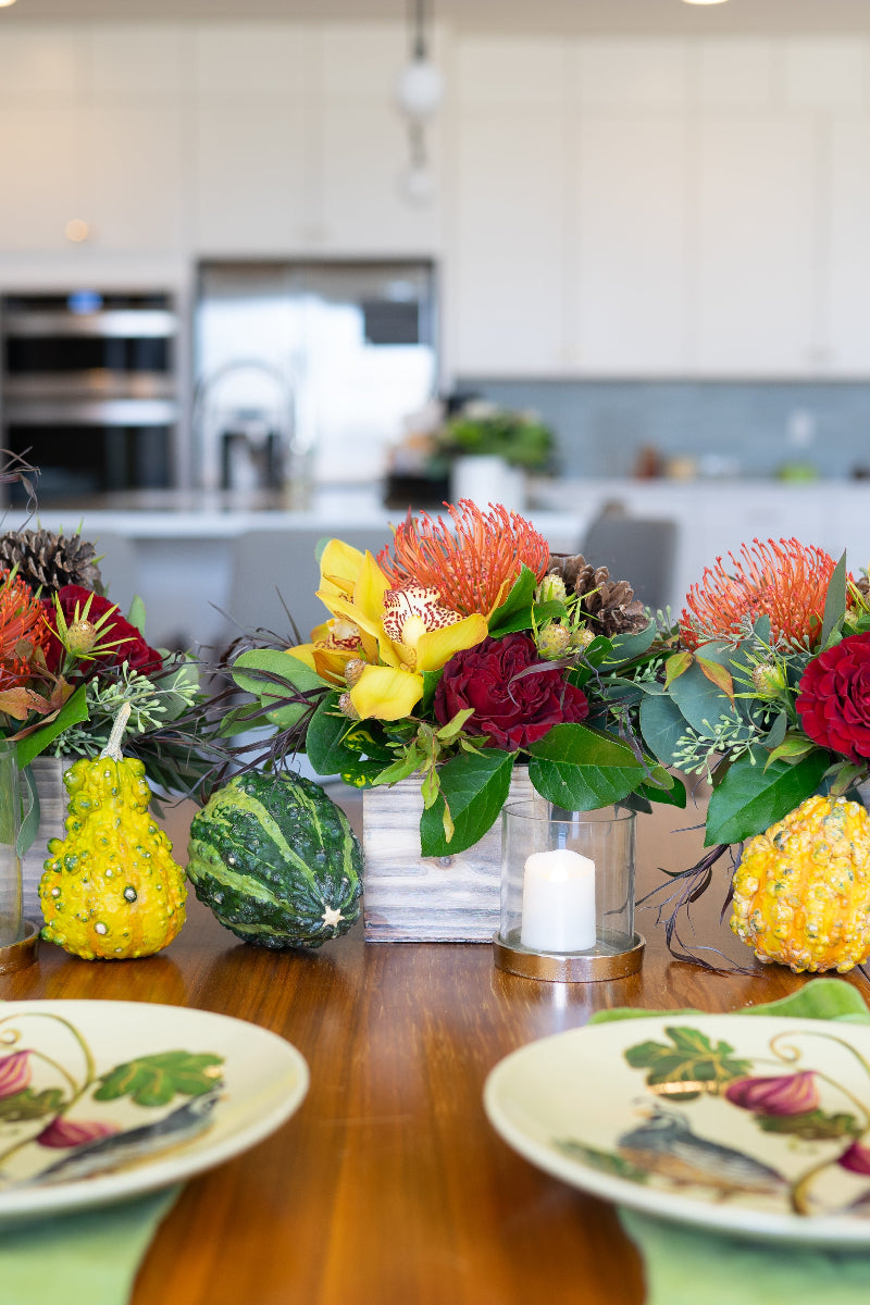 colorful thanksgiving centerpiece bouquets on table with gourds