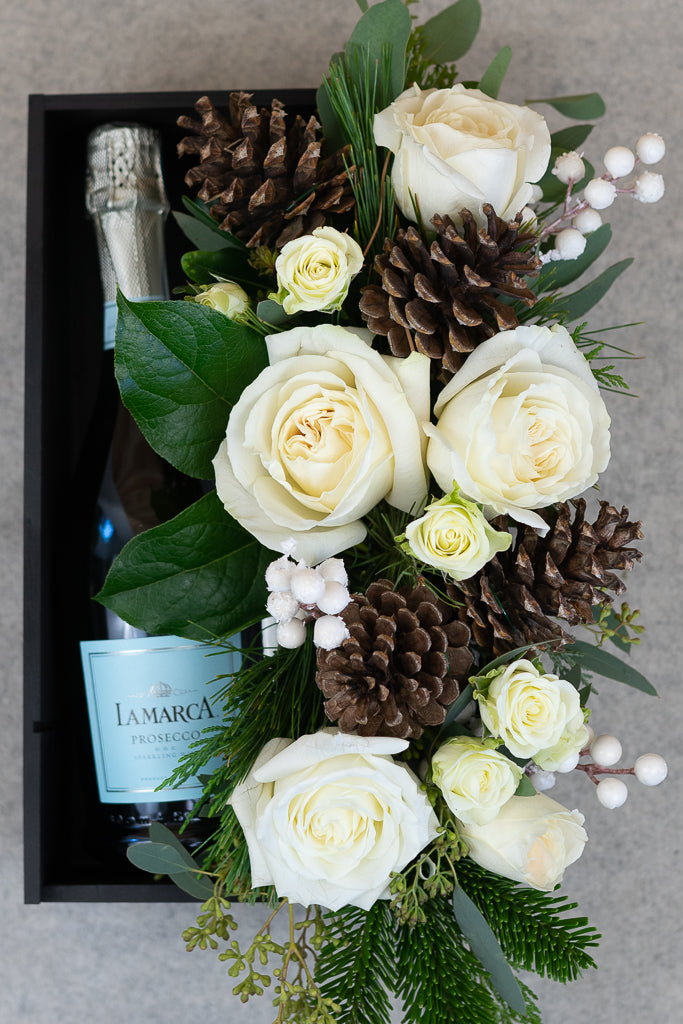 prosecco and flowers white blooms and pine cones
