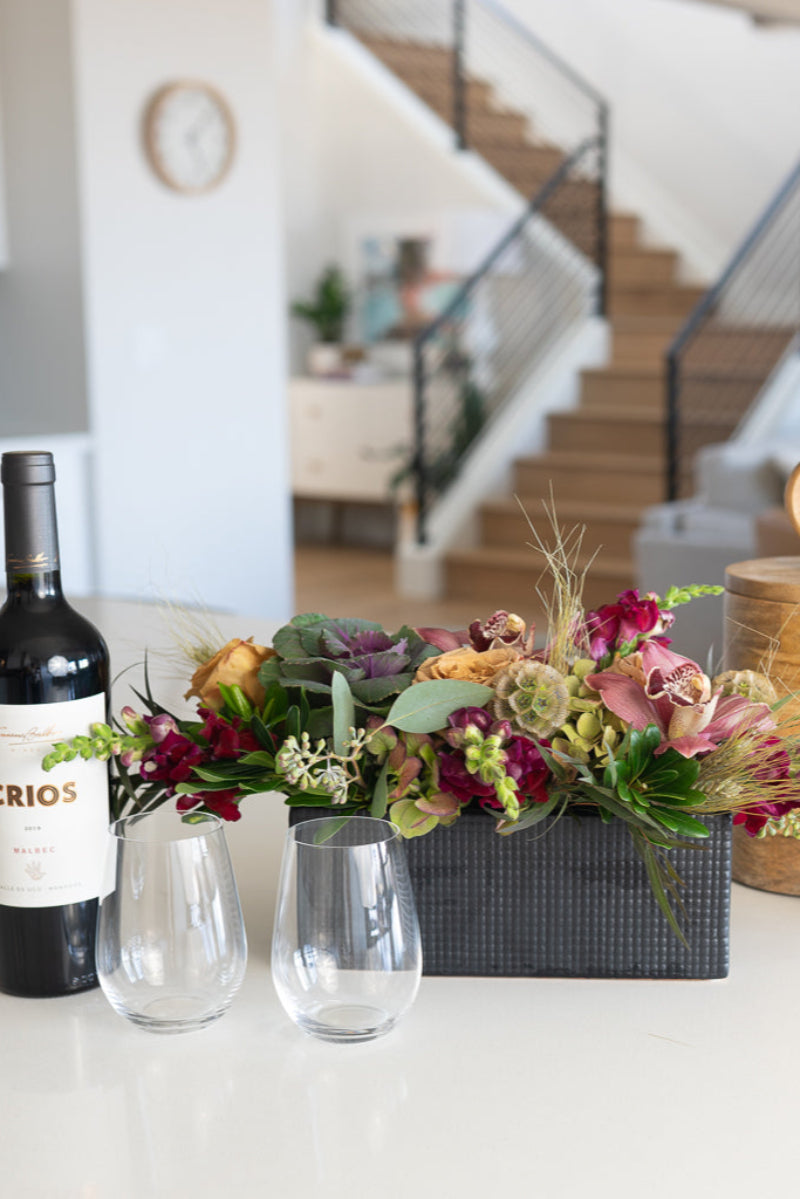 lifestyle shot of floral centerpiece and wine gift box on kitchen island