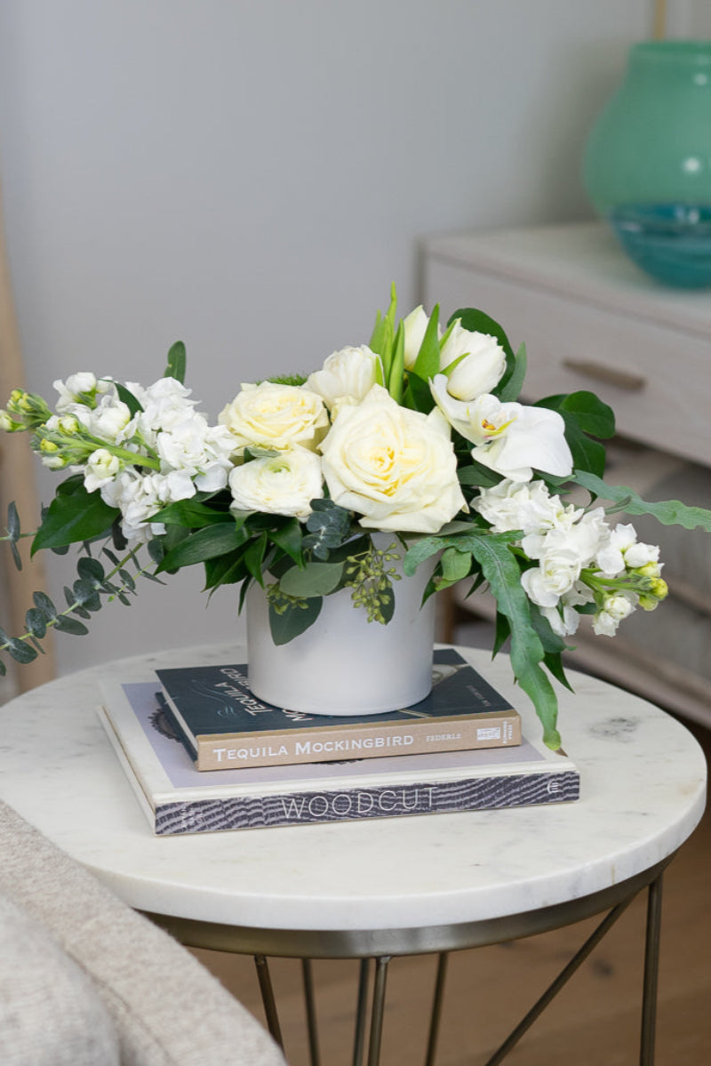 white flower bouquet with roses on a side table